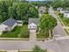 Aerial view of a two-story house in a residential neighborhood with tree-lined streets and well-maintained lawns at 702 Calavaras Ln, Knightdale, NC 27545