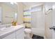 Bathroom featuring a shower-tub combo, toilet, vanity with sink and window at 702 Calavaras Ln, Knightdale, NC 27545