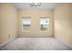 Bedroom featuring neutral carpet, natural light from the windows, and a ceiling fan with lighting at 702 Calavaras Ln, Knightdale, NC 27545