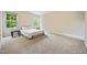 Bright bedroom featuring neutral carpet, beige walls, a comfortable bed and natural light from two windows at 702 Calavaras Ln, Knightdale, NC 27545
