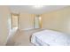 Spacious carpeted bedroom with neutral walls and multiple entryways to other rooms of the house at 702 Calavaras Ln, Knightdale, NC 27545