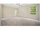 Large bedroom featuring neutral carpet, ceiling fan and two windows providing lots of natural light at 702 Calavaras Ln, Knightdale, NC 27545