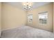 Bedroom featuring neutral carpet, natural light from the windows, and a ceiling fan with lighting at 702 Calavaras Ln, Knightdale, NC 27545