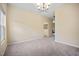 Dining room featuring neutral carpet, natural light from the windows, and a modern light fixture at 702 Calavaras Ln, Knightdale, NC 27545