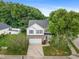 Traditional two-story home with attached garage, well-manicured lawn, and mature trees at 702 Calavaras Ln, Knightdale, NC 27545