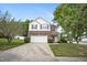 View of the home's front yard, highlighting the driveway, landscaping, and inviting exterior at 702 Calavaras Ln, Knightdale, NC 27545