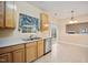 Kitchen featuring wooden cabinets, stainless steel appliances, view into dining area at 702 Calavaras Ln, Knightdale, NC 27545