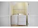 Convenient laundry room equipped with a washer, dryer, and storage shelves at 702 Calavaras Ln, Knightdale, NC 27545