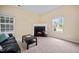 Cozy living room featuring a fireplace, plush carpet, and ample natural light from the windows at 702 Calavaras Ln, Knightdale, NC 27545