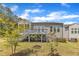 Well-maintained backyard with a view of the deck, flourishing trees, and lush grass at 704 Haven Peak Ln, Wake Forest, NC 27587