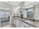 Bathroom featuring double sinks with granite counters, decorative plants and a view of the bedroom at 704 Haven Peak Ln, Wake Forest, NC 27587