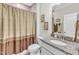 Full bathroom featuring a granite sink, toilet, shower with curtain, and decorative wall art at 704 Haven Peak Ln, Wake Forest, NC 27587