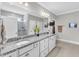 Bathroom featuring double sinks, granite countertops, a large mirror, and a walk-in shower at 704 Haven Peak Ln, Wake Forest, NC 27587