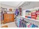 Walk-in closet with custom shelving, hanging racks, and ample storage space for clothes and accessories at 704 Haven Peak Ln, Wake Forest, NC 27587