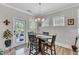 Cozy dining area with wood flooring, a chandelier, and a view to the patio at 704 Haven Peak Ln, Wake Forest, NC 27587