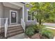 Inviting front entryway with brick steps, white railings, and a charming floral wreath on the front door at 704 Haven Peak Ln, Wake Forest, NC 27587