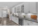 Stylish kitchen features granite countertops, white cabinetry, and a convenient built-in beverage cooler at 704 Haven Peak Ln, Wake Forest, NC 27587