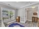 Bright living room features neutral paint, large window, classic rug, and an open doorway at 704 Haven Peak Ln, Wake Forest, NC 27587
