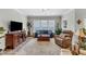 Bright living room featuring hardwood floors, a cozy seating area, and a large window at 704 Haven Peak Ln, Wake Forest, NC 27587