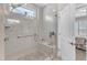 Modern shower with glass door, bench seating, and natural light from the above window at 704 Haven Peak Ln, Wake Forest, NC 27587