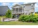 The backyard features a screened porch, patio with fire pit, and stairs leading to the second level at 710 Legacy Falls S Dr, Chapel Hill, NC 27517