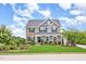 Charming two-story home featuring a beautifully landscaped front yard and a combination of stone and siding accents at 710 Legacy Falls S Dr, Chapel Hill, NC 27517