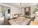 Cozy living room with a stone fireplace, hardwood floors, and elegant furnishings at 710 Legacy Falls S Dr, Chapel Hill, NC 27517
