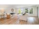 Bright living room with hardwood floors, modern fireplace, stylish furniture, and a glass door leading outside at 710 Legacy Falls S Dr, Chapel Hill, NC 27517