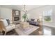 Cozy living room featuring a stone fireplace, comfortable seating, and hardwood floors, perfect for relaxing and entertaining at 710 Legacy Falls S Dr, Chapel Hill, NC 27517