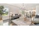 Inviting living room with a view into the kitchen, featuring a chandelier and hardwood flooring at 710 Legacy Falls S Dr, Chapel Hill, NC 27517