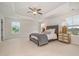 Bright and airy main bedroom featuring a tray ceiling, soft carpet, and ample natural light at 710 Legacy Falls S Dr, Chapel Hill, NC 27517