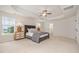 A bright main bedroom with a tray ceiling, a ceiling fan, and two windows at 710 Legacy Falls S Dr, Chapel Hill, NC 27517