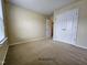 A well-lit bedroom with neutral carpet, closet space, and a bright window at 711 Keystone Park Dr # 78, Morrisville, NC 27560
