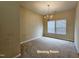 Bright dining room with a chandelier and natural light coming in from the big windows at 711 Keystone Park Dr # 78, Morrisville, NC 27560