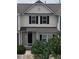 Charming townhouse exterior with black shutters, a welcoming front porch, and verdant landscaping at 711 Keystone Park Dr # 78, Morrisville, NC 27560