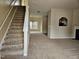 Inviting living room with neutral carpet, a staircase, and an open layout leading to the dining area at 711 Keystone Park Dr # 78, Morrisville, NC 27560