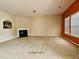 Spacious living room featuring neutral carpet, a fireplace, and natural light from the windows at 711 Keystone Park Dr # 78, Morrisville, NC 27560