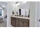 Bathroom with double vanity, modern fixtures, and a view into the bedroom at 717 Utley St, Holly Springs, NC 27540