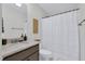 Bathroom view with a curtained shower, vanity and toilet at 717 Utley St, Holly Springs, NC 27540