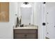 Bathroom with a modern vanity, gray countertop, and a mirror with decorative lighting at 717 Utley St, Holly Springs, NC 27540