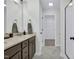 Bathroom features marble floors, granite vanity, and a walk in closet/storage area at 717 Utley St, Holly Springs, NC 27540