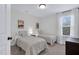 This bedroom has neutral-toned walls, 2 twin beds, and natural light at 717 Utley St, Holly Springs, NC 27540
