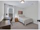 Cozy bedroom featuring a desk, a chair, a nightstand, and natural light at 717 Utley St, Holly Springs, NC 27540