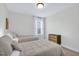 This bedroom features two twin beds with neutral colors and natural lighting at 717 Utley St, Holly Springs, NC 27540
