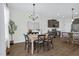 Dining area with hardwood floors, a decorative light fixture, and seamless flow to the kitchen, ideal for Gathering gatherings at 717 Utley St, Holly Springs, NC 27540