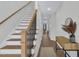 Warm and inviting entryway with a staircase and table, creating a welcoming ambiance for guests at 717 Utley St, Holly Springs, NC 27540
