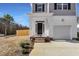 Inviting front entrance with a cozy porch and landscaped front yard, creating a welcoming first impression at 717 Utley St, Holly Springs, NC 27540