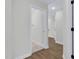 Hallway leading to bathroom has wood floors and a view of other areas at 717 Utley St, Holly Springs, NC 27540
