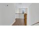 Hallway with hardwood floors, black metal railings, wood banisters, and a window at 717 Utley St, Holly Springs, NC 27540