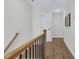 Upstairs hallway shows wood floors and a view of another area at 717 Utley St, Holly Springs, NC 27540